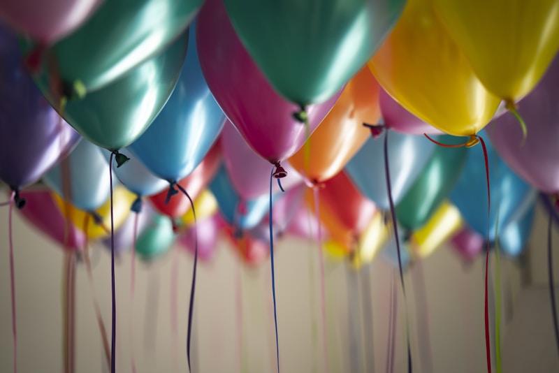 Soft birthday party decor with balloons and coordinated details